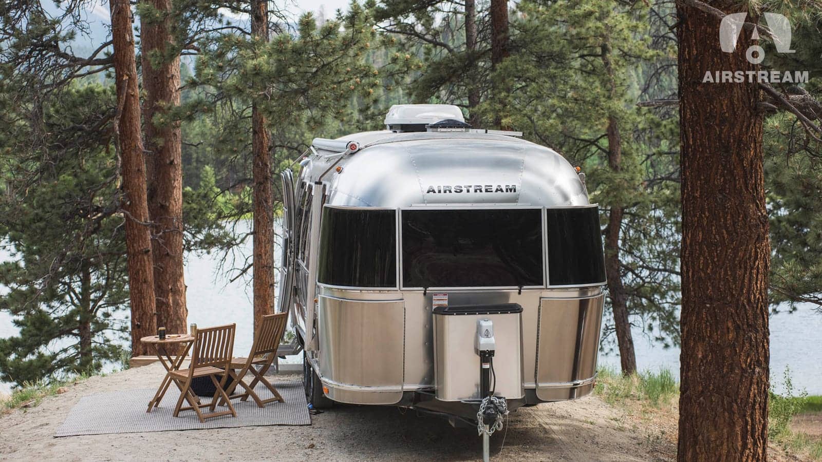 Airstream travel trailer at a forest campsite